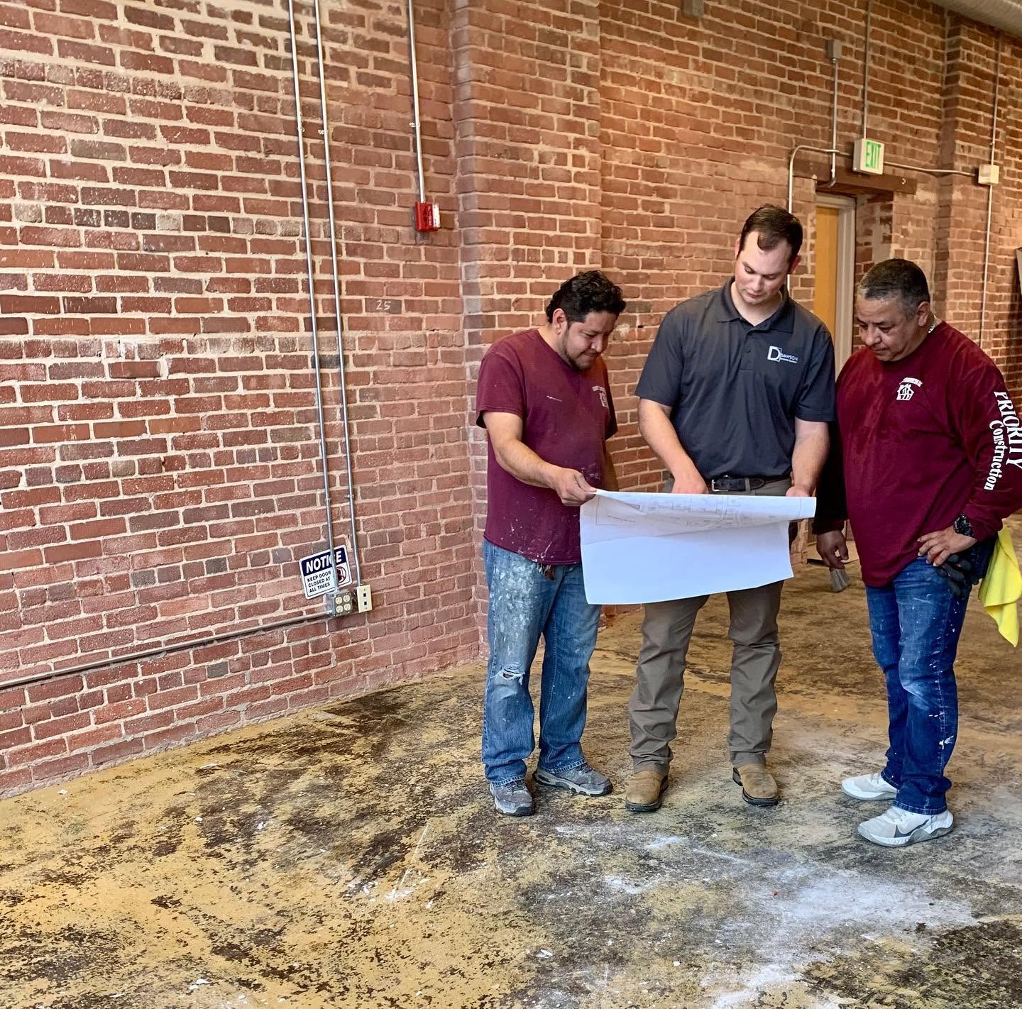 Phillip Dawson reviewing plans with the crew on site