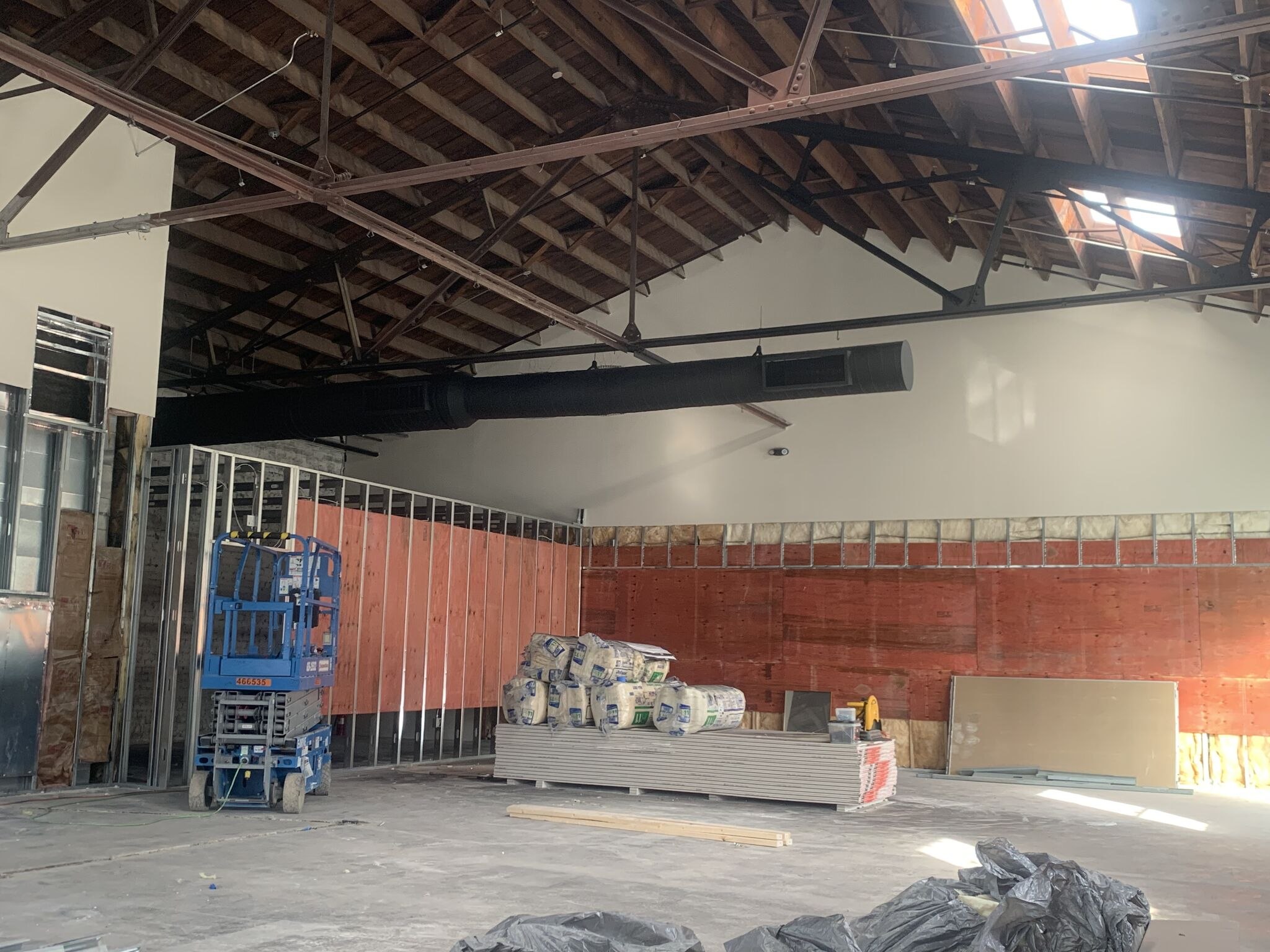 The warehouse's truss roof and skylights during the Schumacher build-out