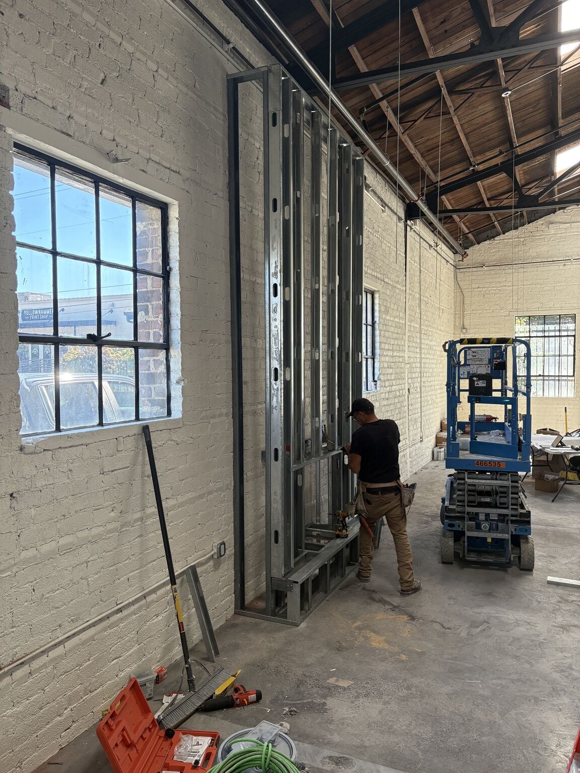 A Dawson crew member at work on the showroom's feature wall framing