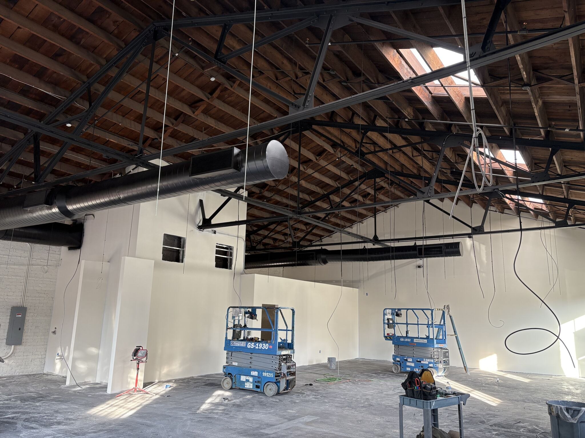 New white partitions under the timber trusses at the Schumacher showroom